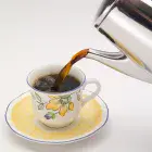 A close-up of coffee being poured from the 6-cup Stainless Steel Coffee Maker.