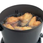 A close-up of the top of the DualDaddy electric deep fryer with the divider removed and large pieces of food frying..