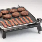 A close-up of the Tilt-n-Fold XL Electric Griddle showing the tilted cooking surface.