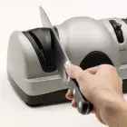 A knife being sharpened in stage one of the Professional EverSharp three-stage electric knife sharpener.