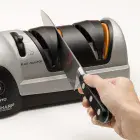 A knife being sharpened in stage two of the Professional EverSharp three-stage electric knife sharpener.