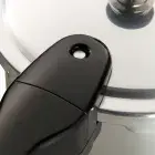 A close-up of the cover lock indicator on the 4-Quart Stainless Steel Pressure Cooker.