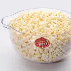 The cover of the Orville Redenbacher's Stirring Popper by Presto flipped over for use as a serving bowl.