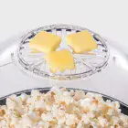 Orville Redenbacher's Stirring Popper by Presto with butter being melted as popcorn pops.