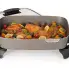 The 16-inch Electric Skillet with the cover off and chicken cooking inside.