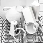 The SaladShooter&reg; electric slicer/shredder food chamber, food guide, and processing cones in a dishwasher.