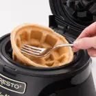 A close-up of a waffle being removed from the Belgian Waffle Bowl Maker