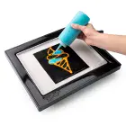 Tthe PanGogh Pancake Art Griddle with an art template being filled with batter.