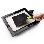 The PanGogh Pancake Art Griddle with an art template being peeled.