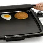 A close-up of the Cool-touch Electric Griddle/Warmer Plus with the tray being moved forward for steaming.