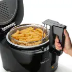 A close-up of the CoolDaddy cool-touch deep fryer as the handle is lifted. French fries are in the basket.