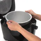 A close-up of the CoolDaddy cool-touch deep fryer as the pot is being removed.