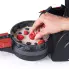 A close-up of the Stuffler stuffed waffle maker with waffle batter on the cooking grid as a raspberry is placed in he batter.