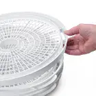 The Dehydro Electric Food Dehydrator with the top tray being lifted.