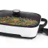 The Presto Precise 16-inch Tuxedo digital precision skillet multi-cooker with the cover on and green beans, peppers, and walnuts cooking inside.
