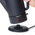 A close-up of the Cordless-serve 12-cup Stainless Steel Coffee Maker pot being removed from the power base.