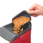 A close-up of the butter melter being used to pour popcorn kernels into the PopLite hot air popper.