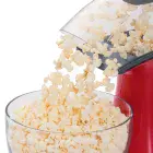 A close-up of the chute of the PopLite hot air popper with popped corn flowing into a bowl.