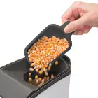 The butter melter being used to pour popcorn kernels into the Orville Redenbacher's hot air popper by Presto.