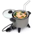 The Kitchen Kettle deep fryer/multi-cooker with the basket hooked to the rim. Steamed food is in the basket.