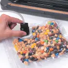 A vacuum tube being used on a  FreshDaddy Vacuum Sealer Zipper Bag with Port.