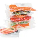 An array of foods sealed in FreshDaddy Vacuum Sealer Zipper Bags with Ports.