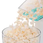 A close-up of the chute of the PopLite hot air popper with popped corn flowing into a bowl.