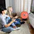 Teens playing a video game with the HeatDish Plus Tilt parabolic electric heater.