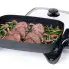 The 16-inch Electric Skillet with the cover off and beef cooking inside.