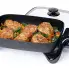 The 16-inch Electric Skillet with the cover off and chicken cooking inside.