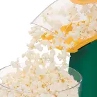 A close-up of the chute of the PopLite hot air popper as popped corn flows into a bowl.