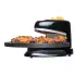 The Pizzazz Plus rotating pizza oven with chicken wings cooking on the baking pan.