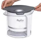The PopLite Our Munch hot air corn popper with the base being nested in the cover.