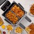 An overhead view of the Dual Basket ProFry immersion element deep fryer with the cover off. Fried foods are in the baskets and on the countertop.