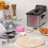 The Stainless Steel ProFry immersion element deep fryer on a kitchen counter with the cover on. Donuts are in the foreground.