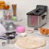 The Stainless Steel ProFry immersion element deep fryer on a kitchen counter with the cover on. Donuts are in the foreground.