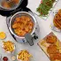 An overhead view of the CoolDaddy cool-touch deep fryer  on a kitchen counter. The cover open fried food is in the basket and around the fryer.