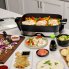 The 16-inch Electric Foldaway Skillet on a kitchen counter with the cover off.