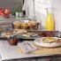 The 22-inch Slimline Griddle on a kitchen counter and cooking pancakes and bacon