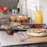 The 22-inch Slimline Griddle on a kitchen counter and cooking pancakes and bacon