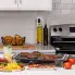 The Tilt-n-Fold XL Electric Griddle on a kitchen counter cooking breakfast sausage and bacon.