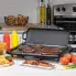 The Cool-touch Electric Griddle/Warmer Plus on a kitchen counter cooking bacon and hamburgers