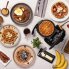An overhead view of the FlipSide Belgian Waffle Maker with a baked waffle on the cooking grid and other baked waffles on plates around the waffle maker.