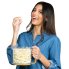 A woman enjoying popcorn. She is holding the Showtime gourmet popper cover which is filled with popped popcorn.