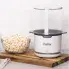 The PopLite Our Munch hot air corn popper on a cutting board. A bowl of popcorn is to the left.