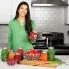 A woman in a kitchen with jars of canned food.
