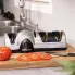 The Professional EverSharp three-stage electric knife sharpener on a kitchen counter with a sliced tomato.