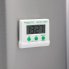 The Electronic Digital Timer with the magnet holding it to the side of a refrigerator.