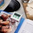 The Electronic Digital Timer attached to a cookbook page by the clip-on back.