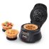 The Belgian Waffle Bowl Maker with the cover open and a waffle bowl on the cooking grid. Two filled waffle bowls are to the left of the unit.